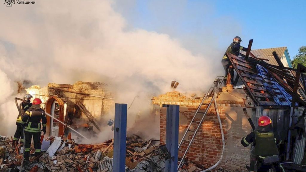 Ukrainian emergency responders outside Okhmatdyt Children's Hospital in Kyiv after a missile strike.